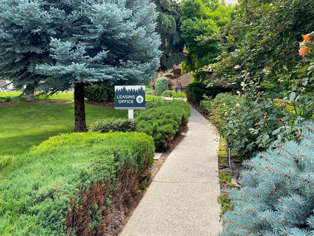 a sidewalk with a sign in that reads leasing office at Castlerock, Wenatchee Washington