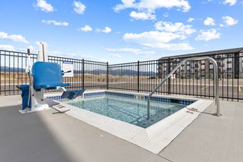 A blue chair sits next to a small pool.at Yellowstone Landing, Montana