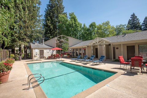 Outdoor swimming pool area with tables and chairs