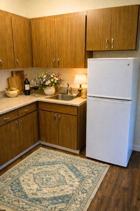 A kitchen with wooden cabinets and a white refrigerator.