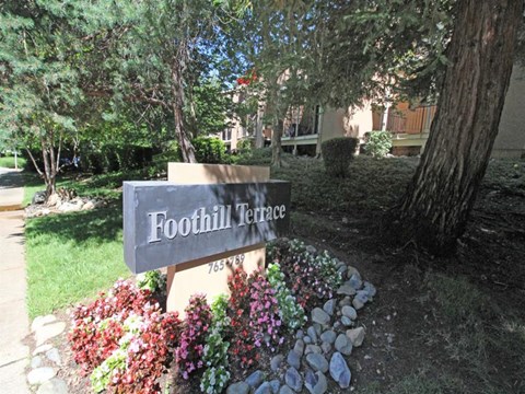 Foothill Terrace sign with flowers around it