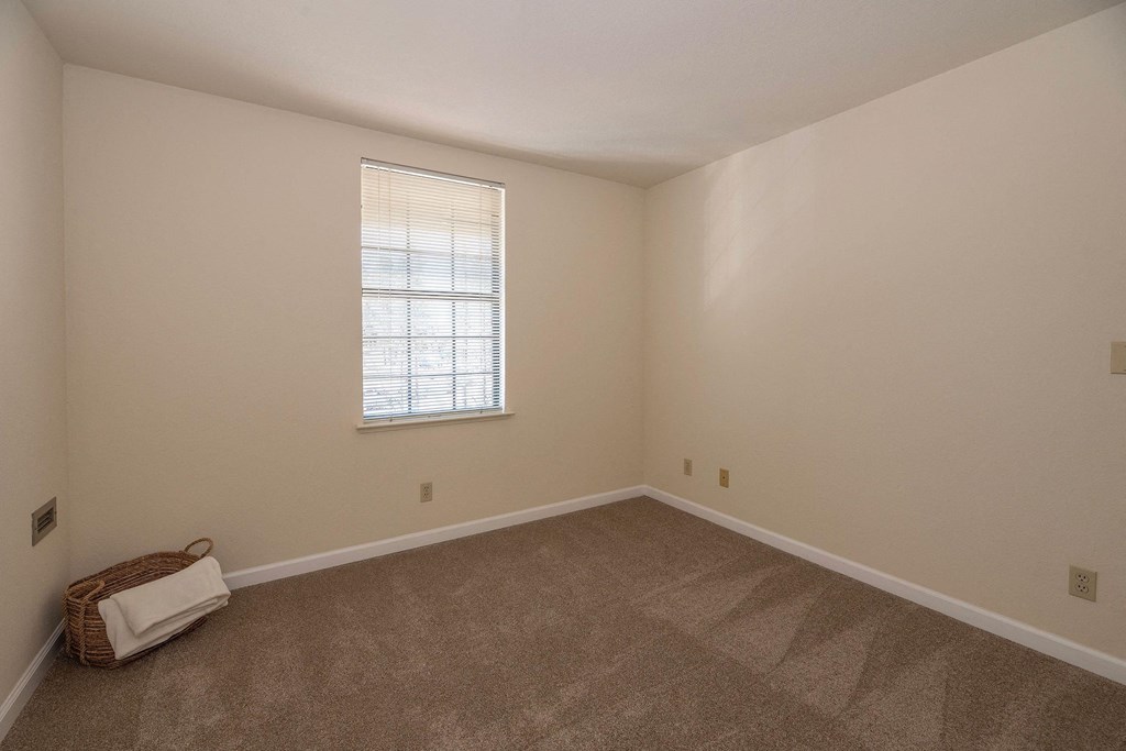an empty living room with carpet and a window at Hilltop Commons Senior Living, Grass Valley, CA
