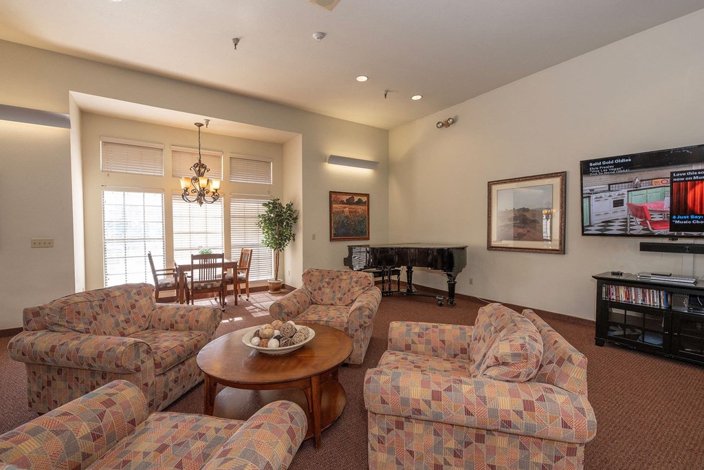 a living room with couches and a table and a television at Hilltop Commons Senior Living, Grass Valley California