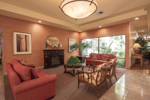 a living room with couches and chairs and a fireplace
