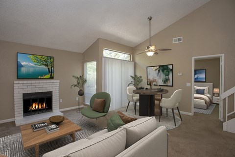 A living room with a fireplace and a television on the wall.