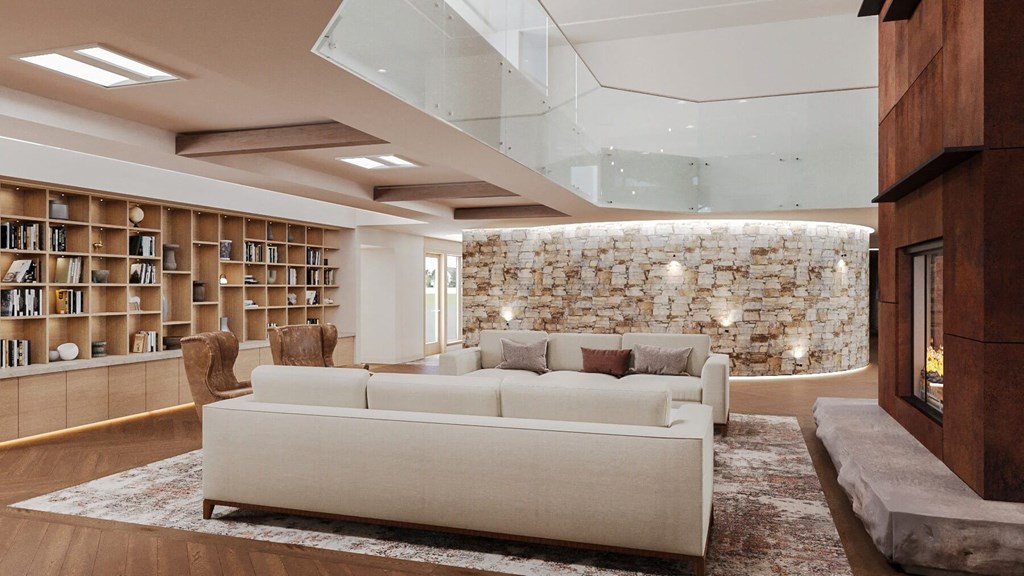 a living room with a white couch and a stone wall at Hearthstone Lodge Senior Residences, Auburn