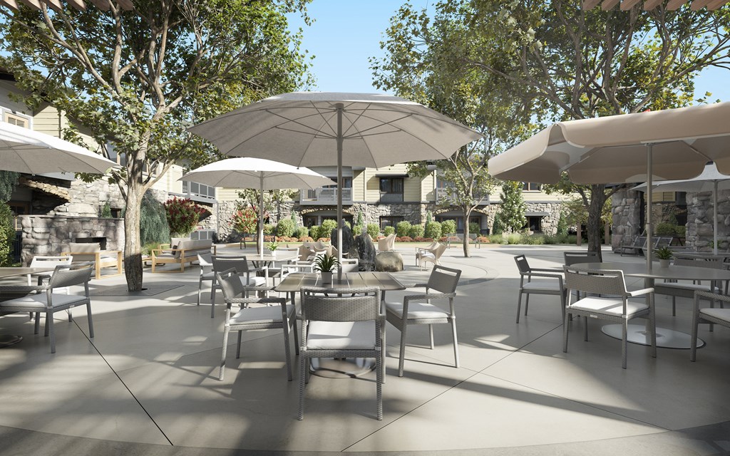 a patio with tables and chairs and umbrellas