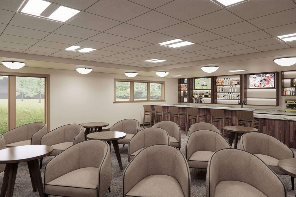a meeting room with chairs and tables and a bar at Hearthstone Lodge Senior Residences, Auburn, CA