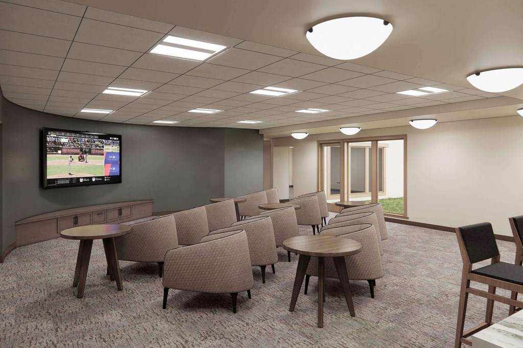 a large room with chairs and a tv at Hearthstone Lodge Senior Residences, Auburn, 95602