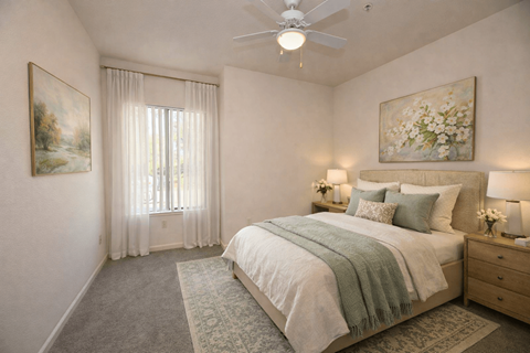 Bedroom with ceiling fan and nightstands at Winding Commons Senior Living Apartments, Carmichael, California
