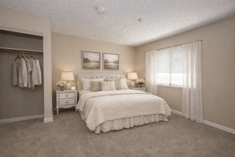 Spacious bedroom with walk-in closet and large window at Roseville Commons Senior Living Apartments, Roseville, CA