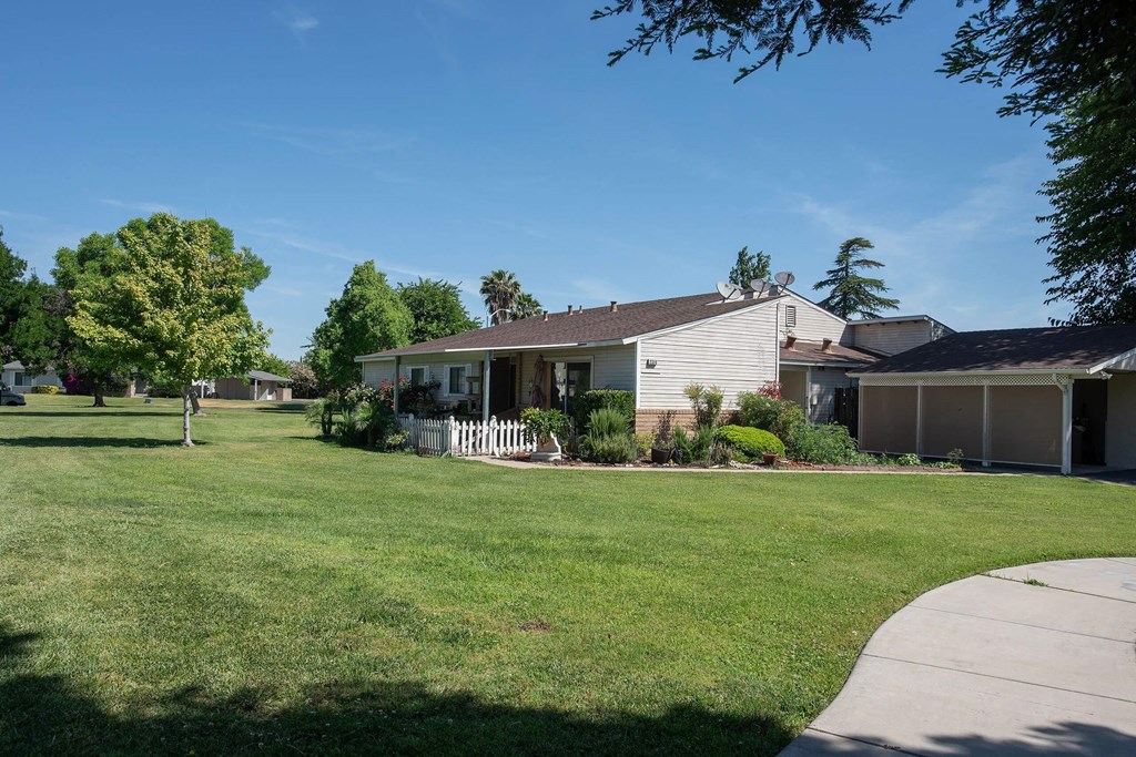 a white house with a yard in front of it at Castle Vista Senior Duplex Community, Atwater, 95301