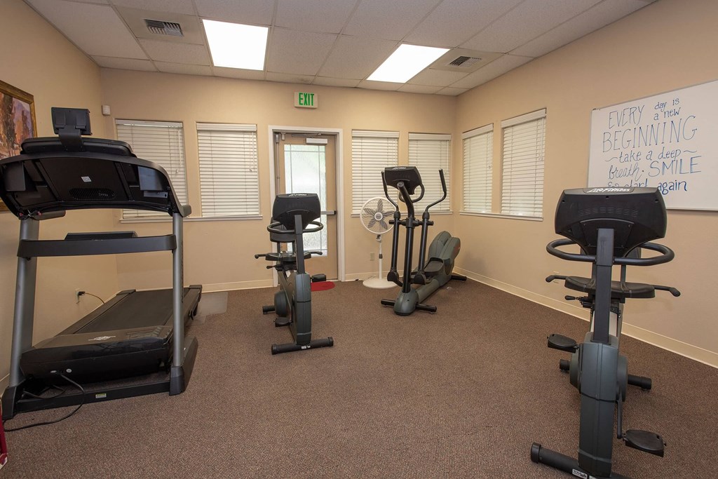 a gym with exercise equipment in a therapy room at Castle Vista Senior Duplex Community, Atwater, CA