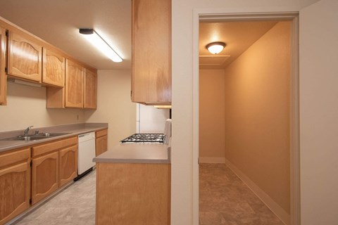 a view of a kitchen with wood cabinets and white appliances