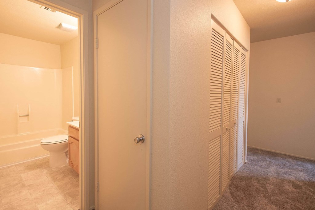 a bathroom with a toilet and a closet at Castle Vista Senior Duplex Community, Atwater