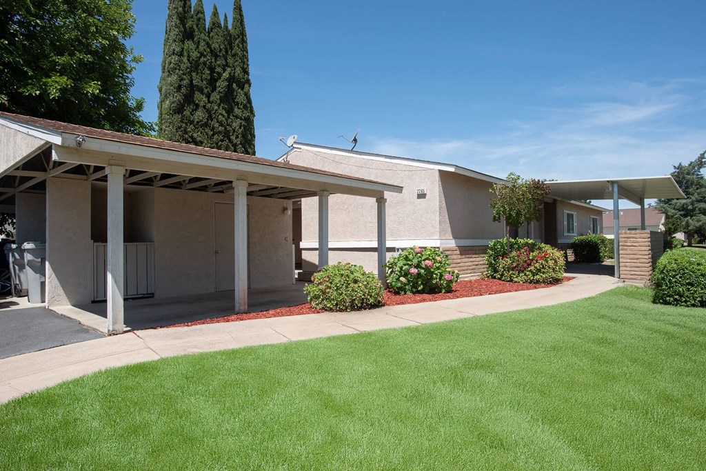 a white building with a lawn in front of it at Castle Vista Senior Duplex Community, Atwater, California