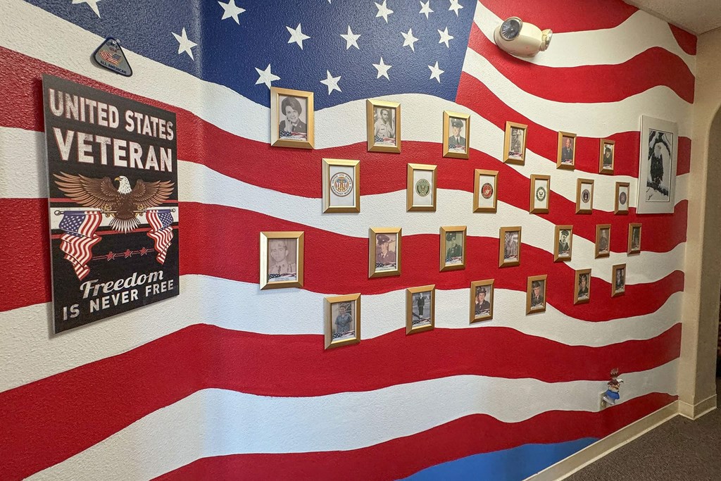 a display of an flag with pictures of veterans on it at Castle Vista Senior Duplex Community, Atwater, California