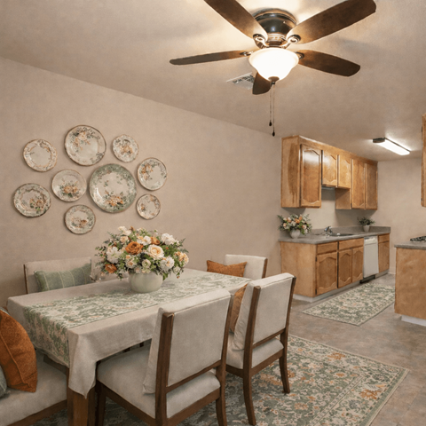 Dining area with decorative plates and kitchenette at Castle Vista Senior Duplex Community Apartments, Atwater