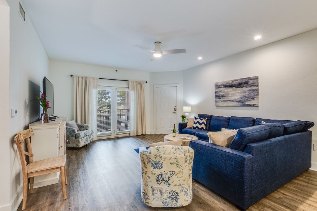 a living room with a blue couch and a tv