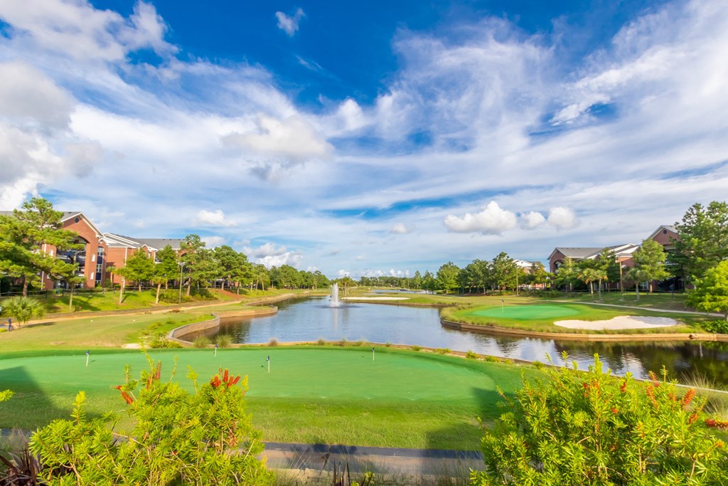 Beautiful golf course with a pond in the middle of it!
