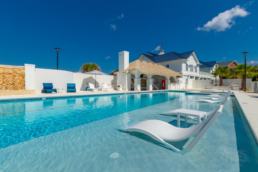 a large swimming pool in front of a house