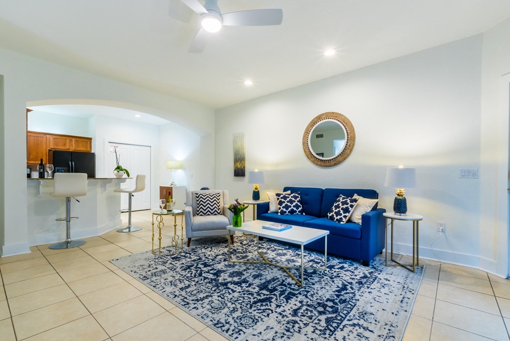 a living room with a blue couch and a rug