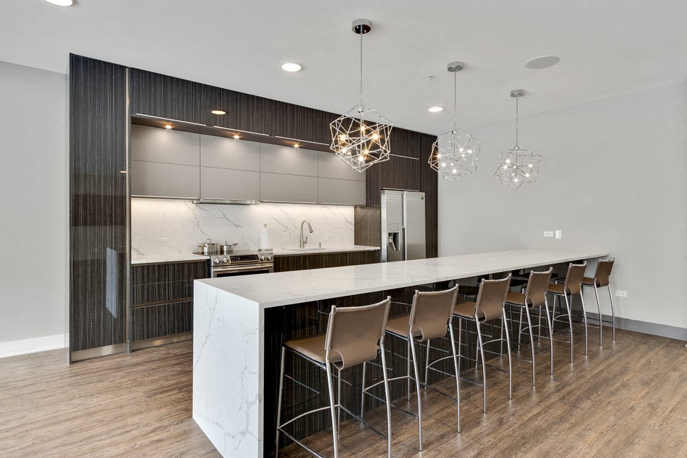 a kitchen with a marble counter top and bar stools