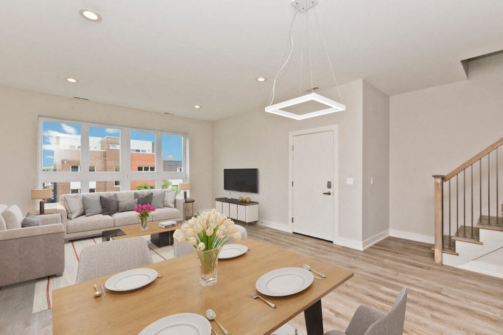a living room and dining room with a table and chairs