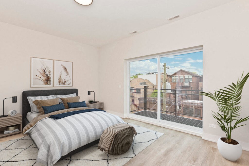 a bedroom with a bed and a large window