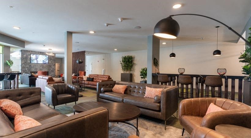 a large living room with couches and chairs