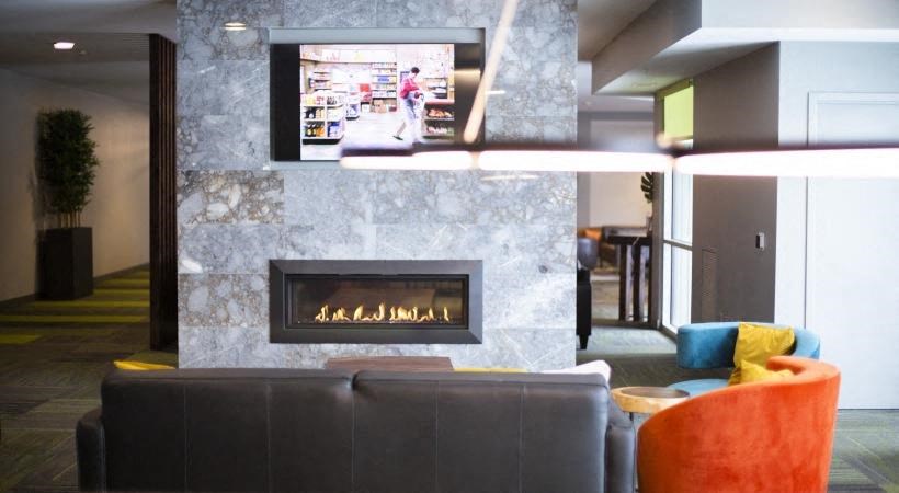 a living room with a fireplace and a television