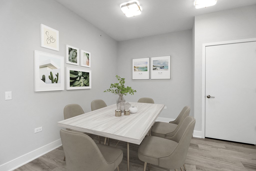 a dining room with a table with chairs and a vase of flowers