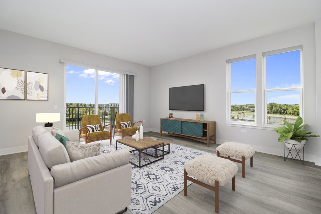 a living room with a couch and chairs and a television
