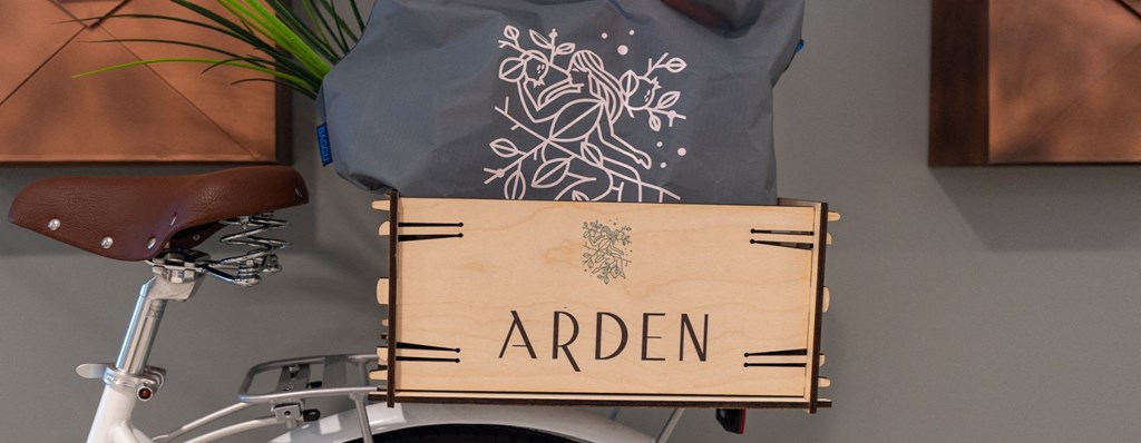 a wooden crate on the back of a bike with the word arden on it