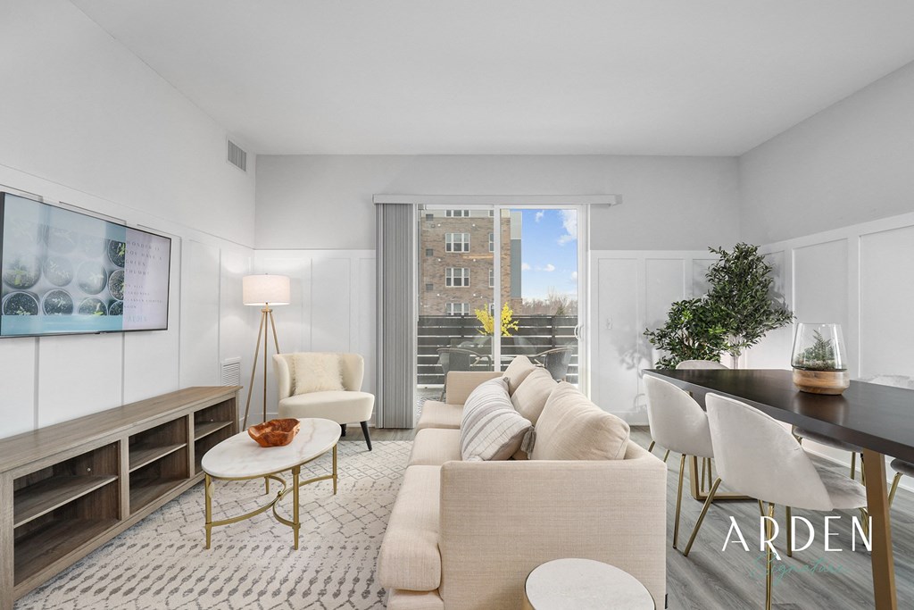 an apartment living room with a couch and a dining table