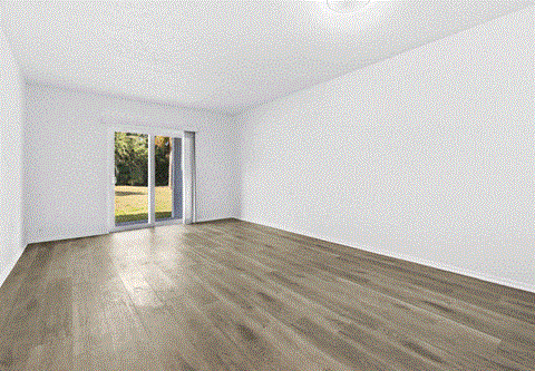 A room with a sliding glass door leading to a green area.