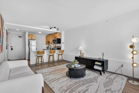 A modern living room with a white sofa and a round coffee table.