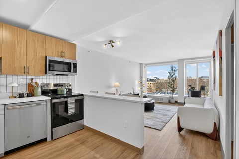A modern kitchen with wooden cabinets and stainless steel appliances.