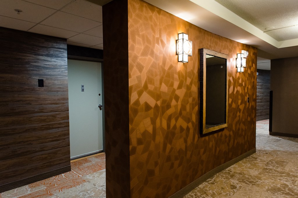 the hallway of a with a mirror on the wall at Hampton Plaza Apartments, Towson, MD