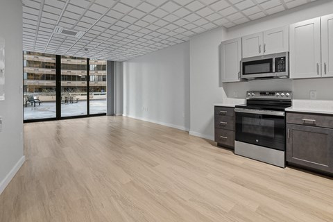 A kitchen with a microwave, oven, and cabinets at Hampton Plaza Apartments, Towson, 21286
