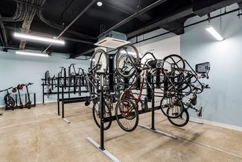 a room with several bikes on display in a rack at Textile Apartments, Cincinnati, OH, 45202