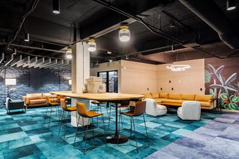 a large room with a table and chairs in a lobby at Textile Apartments, Cincinnati, OH, 45202