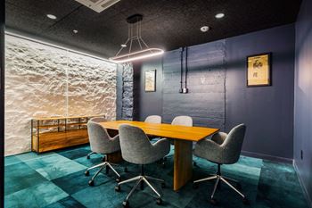 a conference room with a wooden table and chairs at Textile Apartments, Cincinnati, Ohio