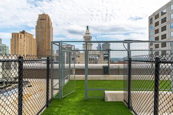 a view of the city from the roof of a building behind a fence at Textile Apartments, Cincinnati