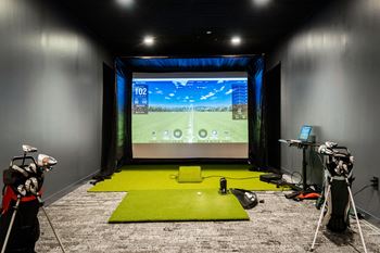 a training room with a screen in the center of the room and two cameras on at Textile Apartments, Cincinnati