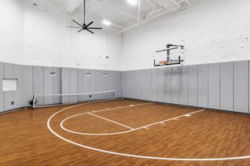 the gym has a hardwood floor and a basketball hoop at Textile Apartments, Ohio