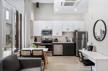 an open kitchen and living room with a table and chairs at Textile Apartments, Cincinnati, 45202