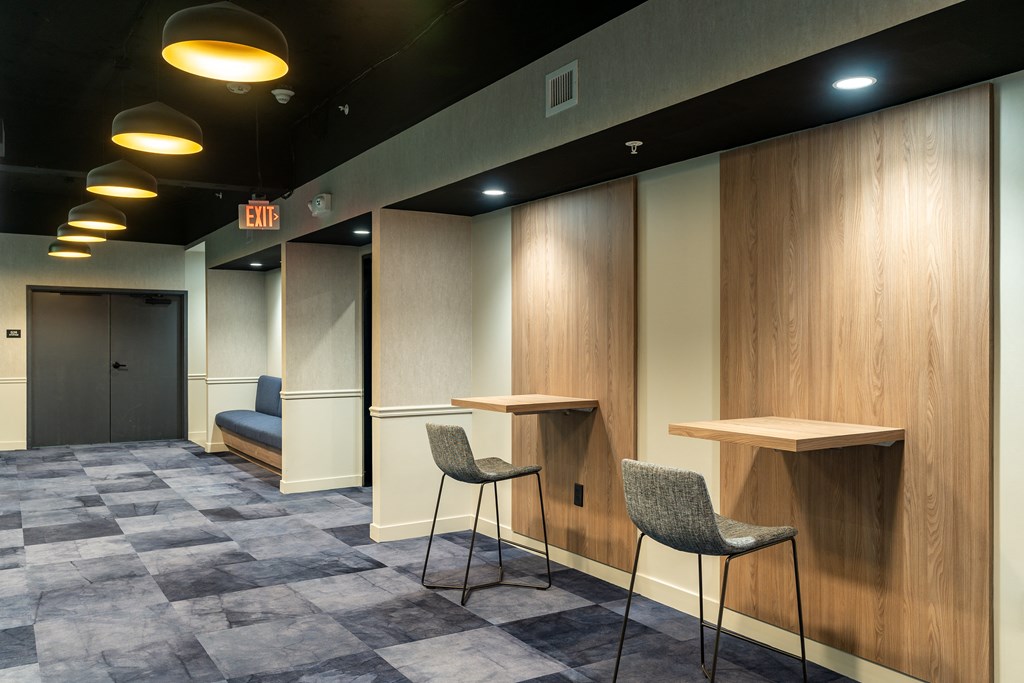 a room with two tables and two chairs and a door at Textile Apartments, Cincinnati, 45202