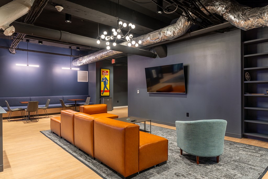 a lobby with couches and chairs and a tv at Textile Apartments, Cincinnati, OH