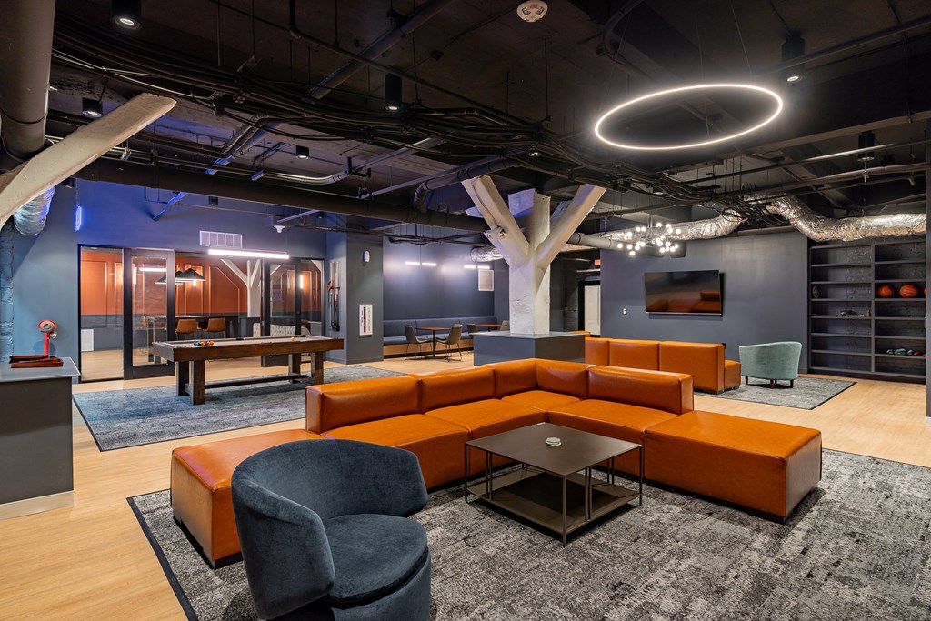 a lounge area with couches and chairs and a ping pong table at Textile Apartments, Cincinnati